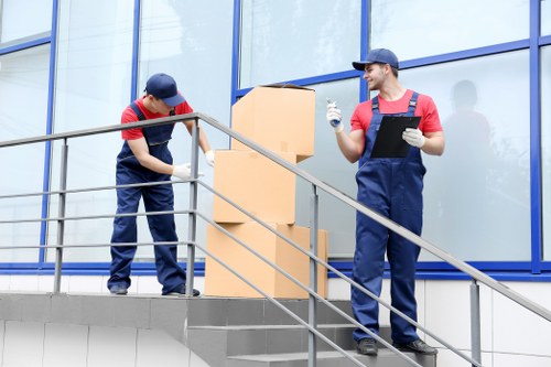 Careful loading of unwanted furniture into a collection vehicle