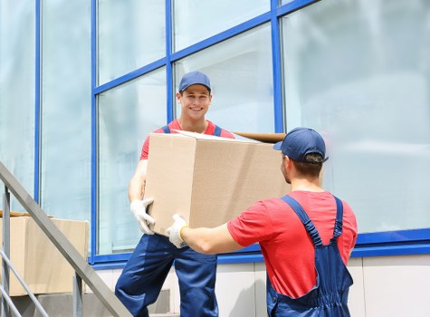 Local moving team organizing packed items for transport