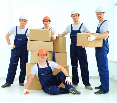 Careful wrapping of fragile household items during a move in Merton