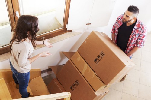 Careful loading of household furniture into a removals vehicle in Merton