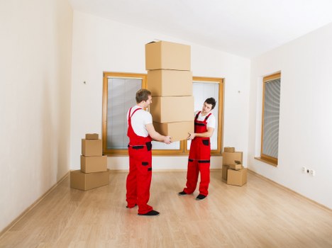 Local movers securing a piano for transport during a Merton removal